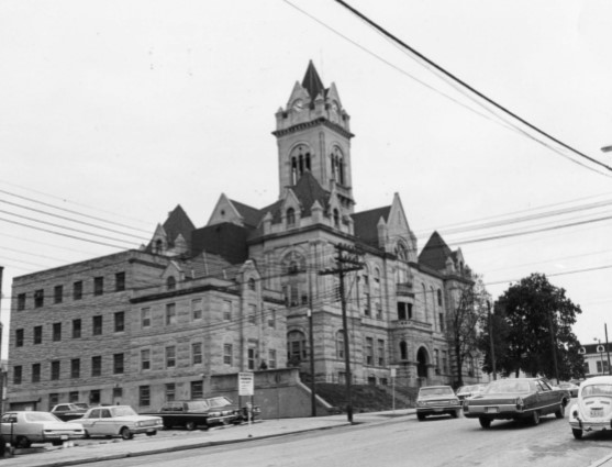 1972 photo, jail-sheriff's house front & left side of building; courthouse behind on right (Holmes)