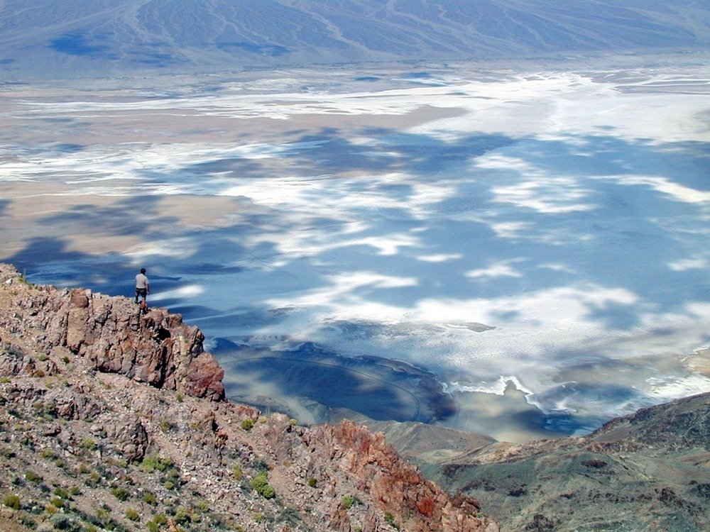 A hiker looks over the valley on top of the Black Mountains. This spot is called "Dante's View."