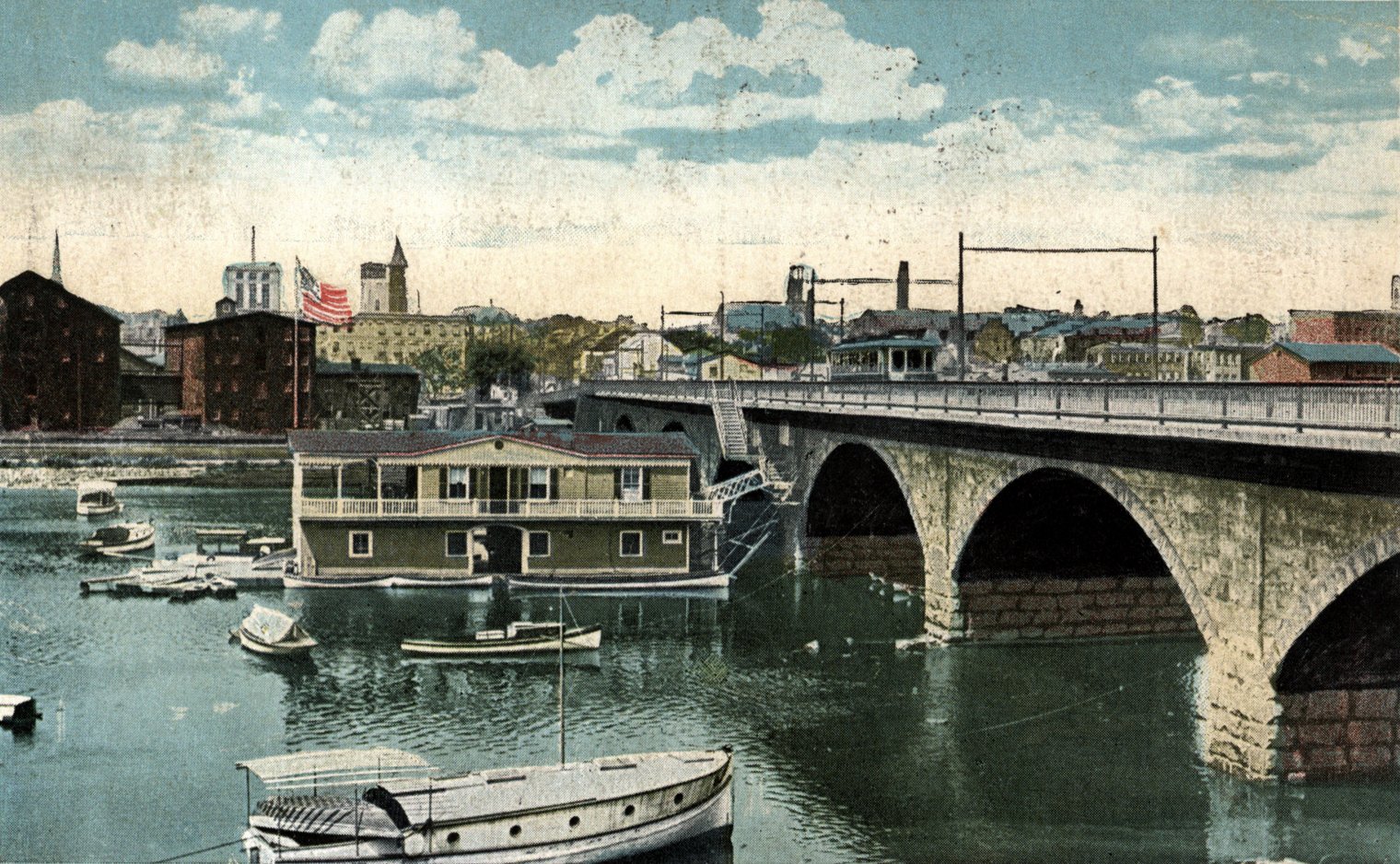 Postcard (ca. 1930) showing the Albany Street Bridge with the boathouse and trolley service.
