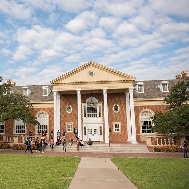 Students relaxing on the steps of Hubbard Hall. This picture was taken before the hall went under renovations in January of 2018. (Picture by Texas Woman's University)