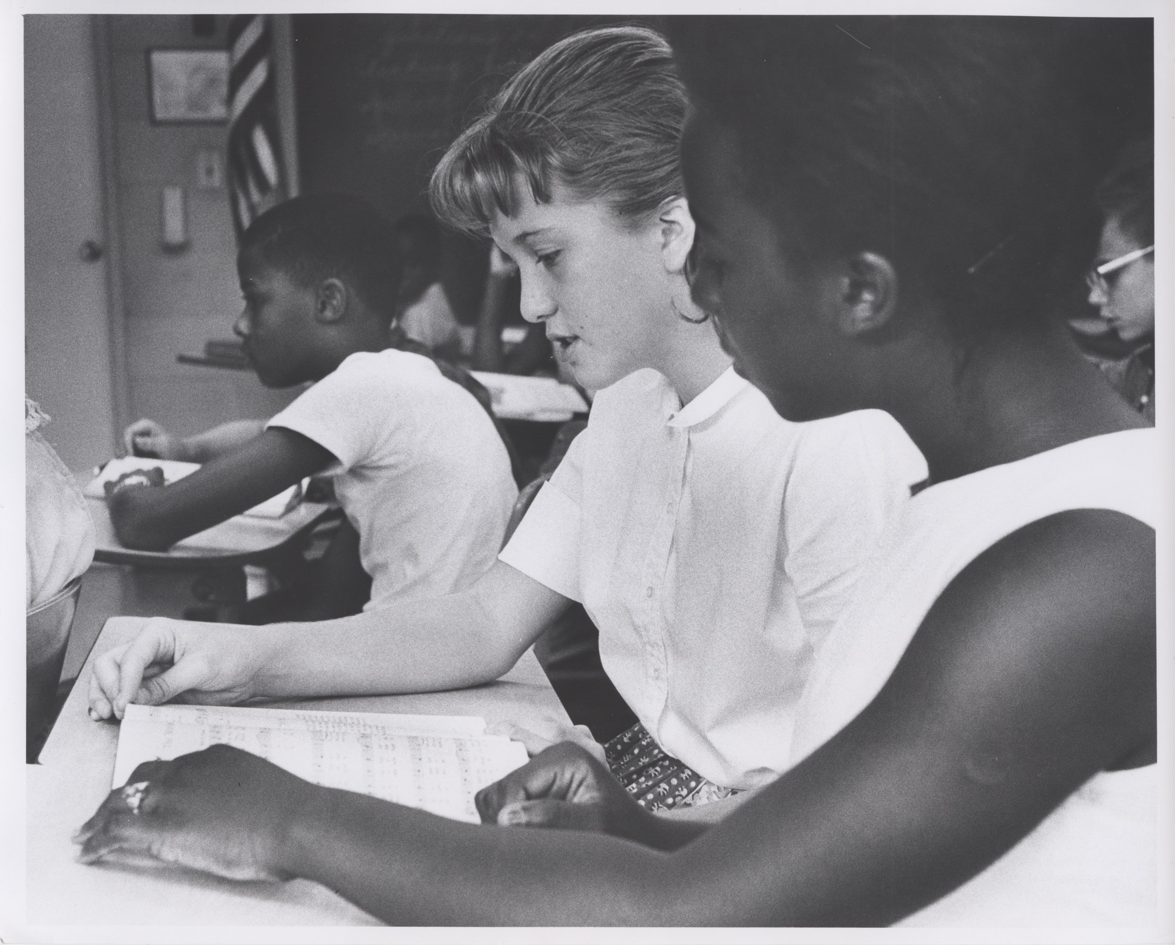 Classmates share a songbook at St. Joseph's School after integration.