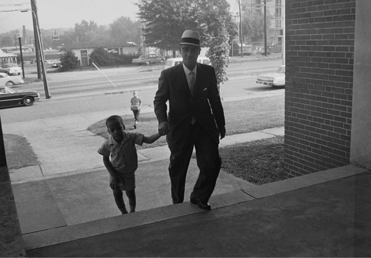 Dr. Sonnie W. Hereford III escorts his son Sonnie Hereford IV into Fifth Avenue School