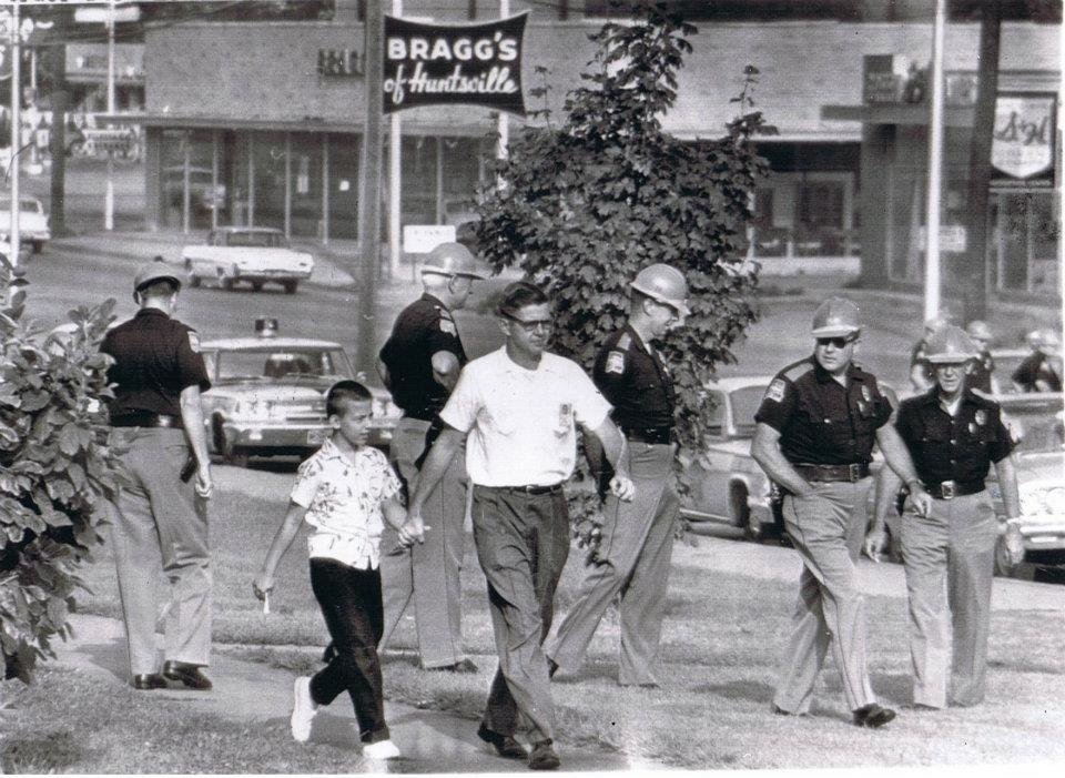 Alabama State Troopers fill the campus of Fifth Avenue School to prevent integration of the school. Note the Bragg's Furniture sign in the background, which still stands today on the north side of Governor's Drive.