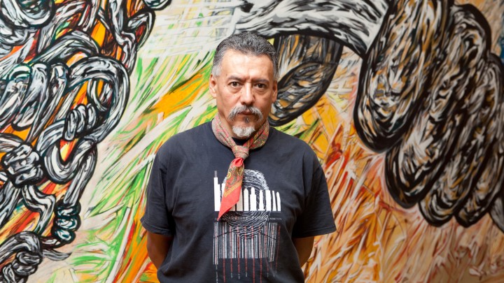 Hector Duarte stands in front of one of his murals (courtesy of the Chicago Architecture Center).