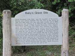 A sign shares the story of Sally McCoy who is buried close to the official McCoy Cemetery