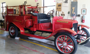 There are six antique vehicles on display.