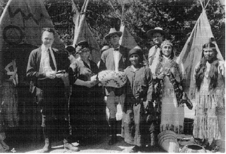 The winner of a basket weaving competition poses with visitors and park officials. 