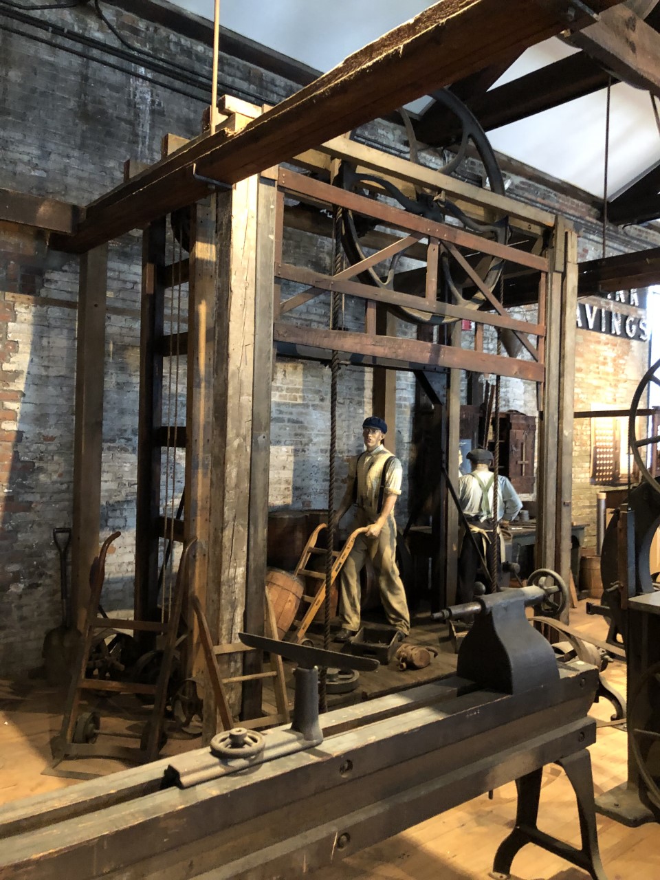 This freight elevator was operated by a large pulley system, seen above the opening.