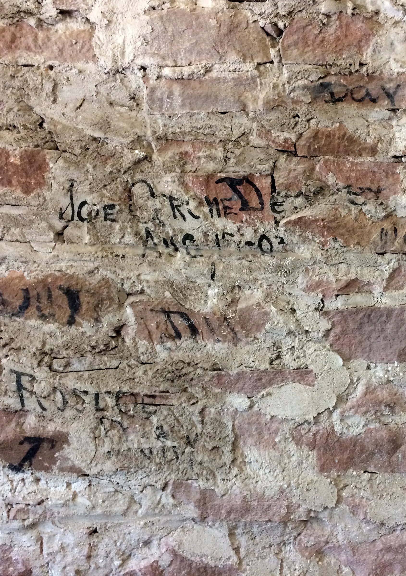 This photo is of an interior wall in the baggage room. During one of the renovations, crewmen's painted initials were discovered.
Photo courtesy of Baiba Lennard.
