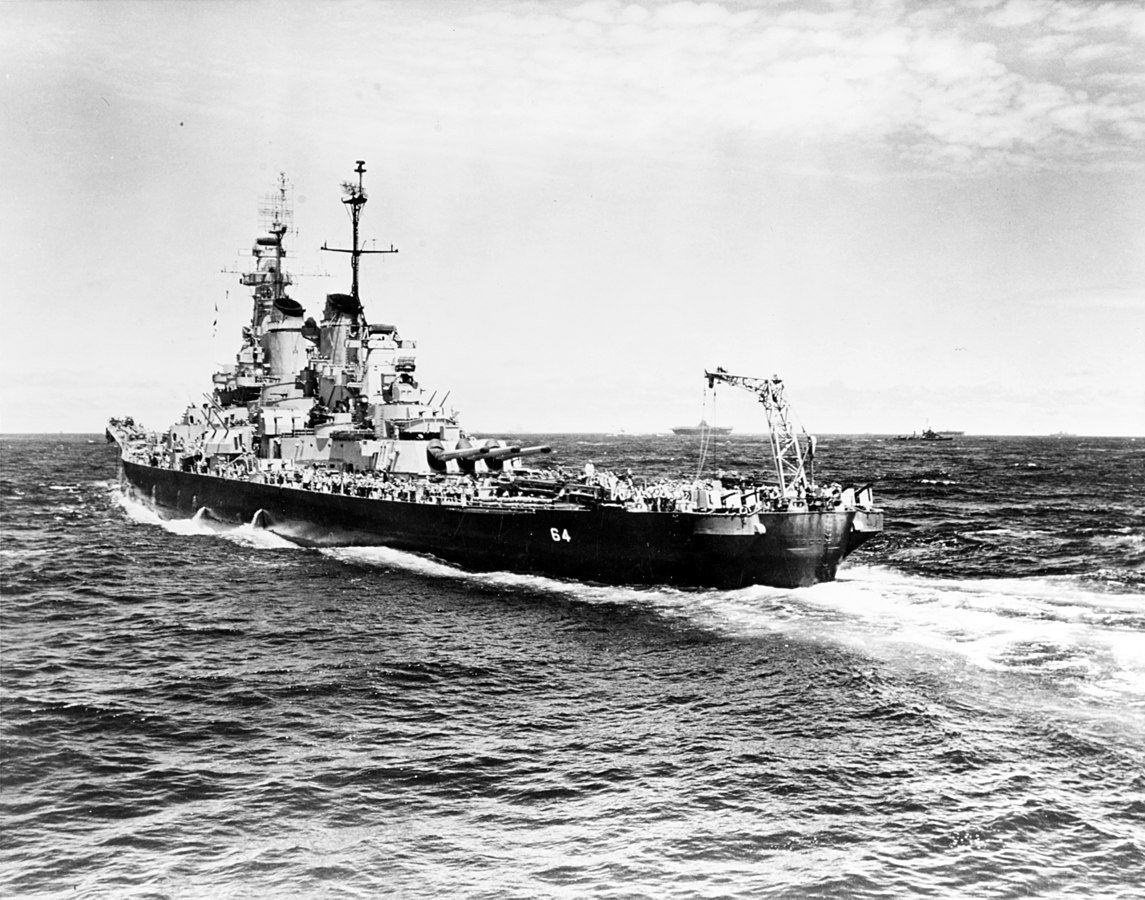 USS Wisconsin escorting aircraft carriers in 1944. The tail crane was used to recover reconnaissance planes. Photo by Lt. Barrett Gallagher, USNR.  National Archives.