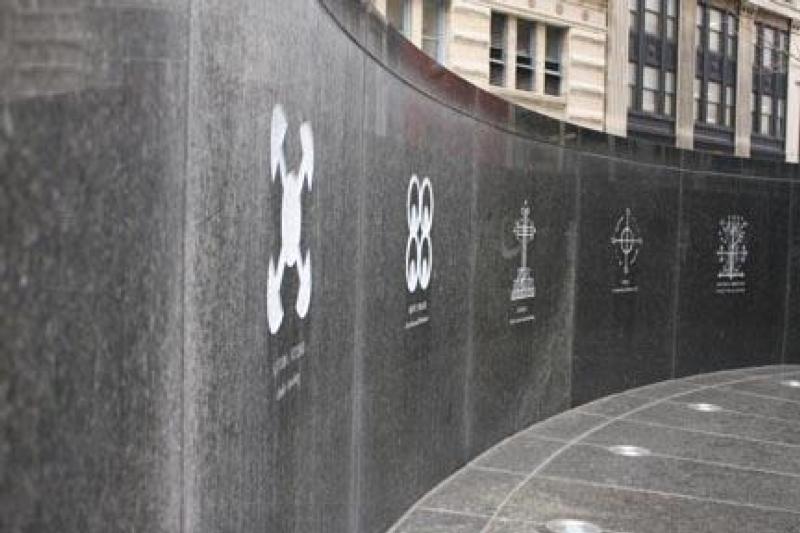 The monument is surrounded by a Circle of the Diaspora inscribed with signs, symbols, and images of the African Diaspora.This Ancestral Wall inside the monument contains rich cultural symbolism.