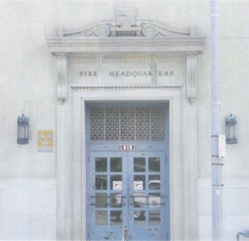 Close-up view of the carved 1920s fire truck over the main entrance