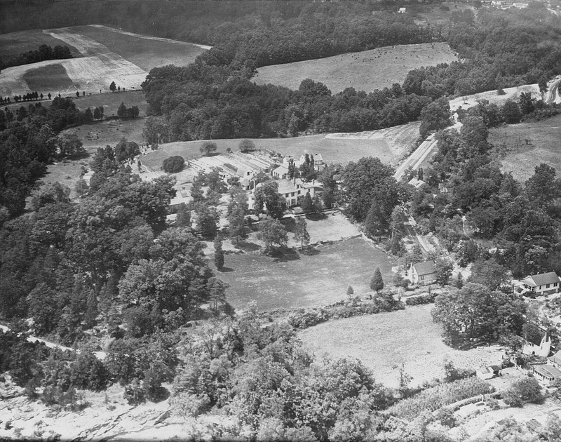 1940s aerial view showing vegetable gardens and orchard behind the garage