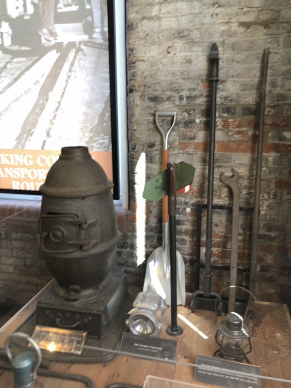 Several tools used by the B&O, including a wood burning stove, tools for repairing rails, and a brakeman's lantern.