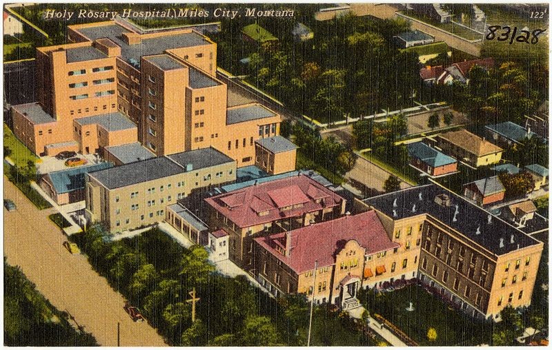 This postcard provides an aerial view of the entire hospital complex including the 1948 high-rise building.