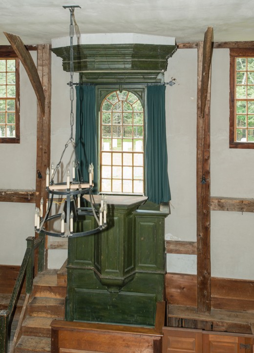 A close up of the raised green pulpit that raises its speaker to nearly the same level as the gallery. 