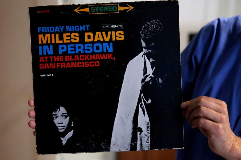 Director of Uptown Tenderloin, Randy Shaw holding up an original copy of a live Miles Davis album recorded at The Black Hawk, a Tenderloin jazz club