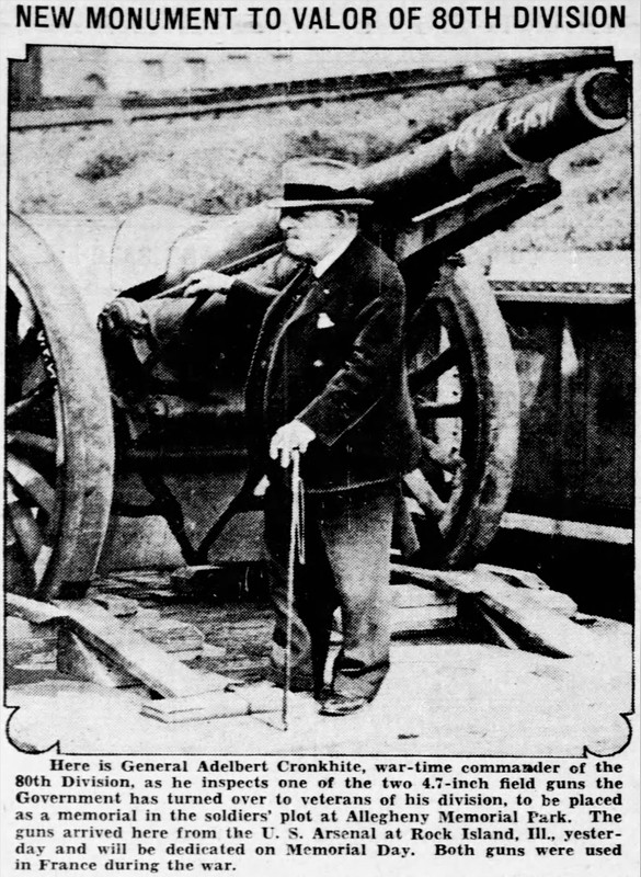 Photo of an older gentleman standing by a large cannon.