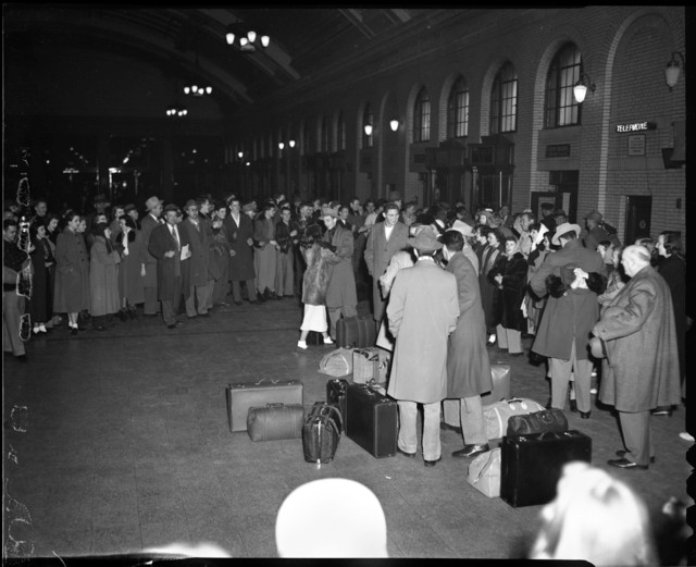 Passengers in line for a departing train (1949)