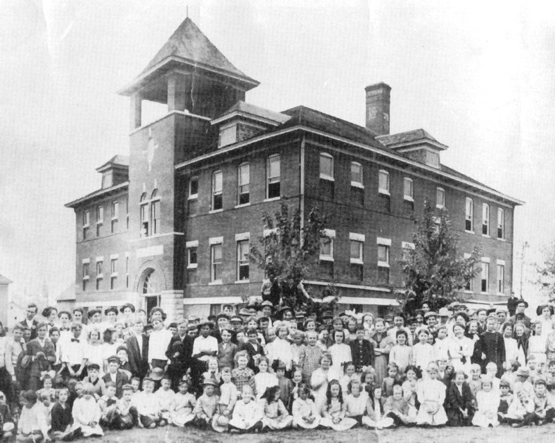 A group of students sitting in front of Garfield Grade School.