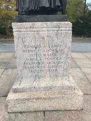 Granite pedestal with the names of the seven men who are being commemorated