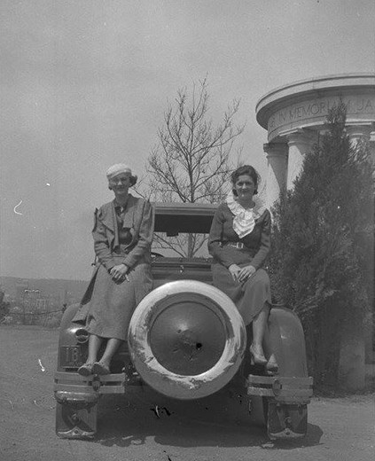 Two women posing in front of the memorial