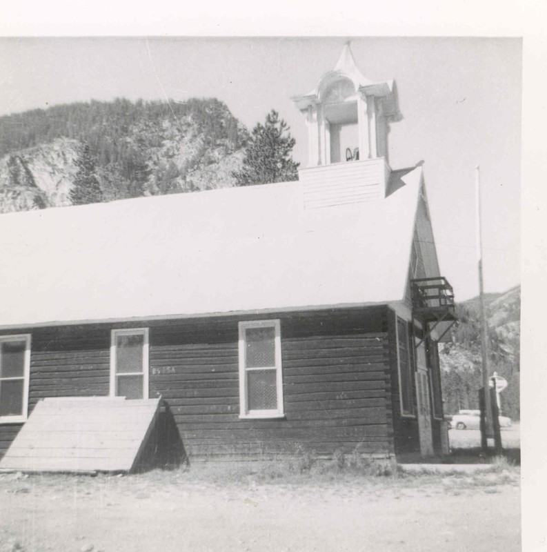 The Frisco Schoolhouse, circa 1956. Note the flag pole and the balcony above the front doors. 