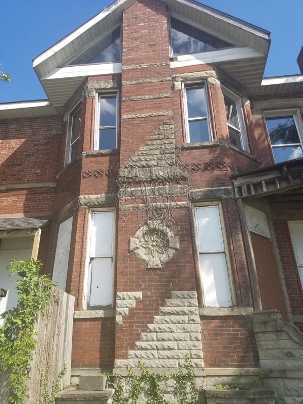 The original stained glass windows do not remain; however, the stone crests still adorn the red brick walls. 