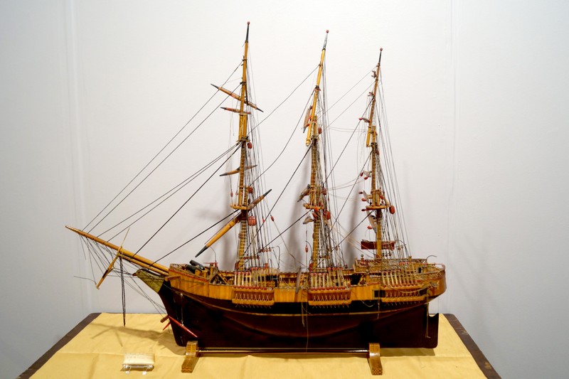 Enter a curatorial mystery:  This model square - rigger also has a burglar story attached.  A 1966 curator's letter in the Mark  Twain House files says that it was built by a burglar in jail for "committing thefts and lurking" in the Nook Farm area in 1878.   The name of the burglar is noted at John W. Hart.  During a recent cleaning of the ship model a card was found wedged into it.  It is one of Olivia Clemens's visiting cards with "Mrs. S.L. Clemens printed on it, and the written note wishing Sir Master Jack Bunce Sincere Regards. 