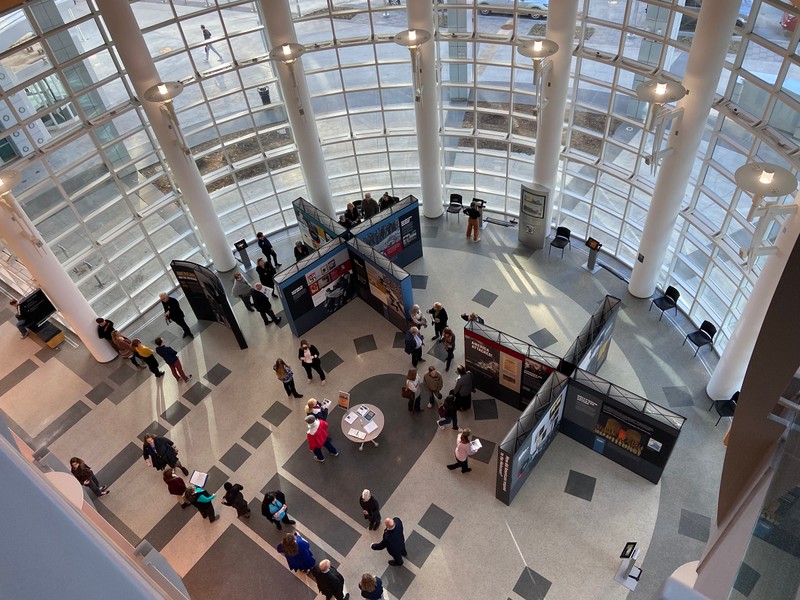 Overhead shot of the Americans and the Holocaust exhibit panels while people view the panels and kiosks.