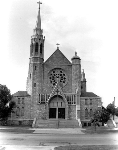 Picture of Holy Name Catholic Church, looking north (south side of the building), with East 23rd Street visible in the foreground . Picture taken November, 2002