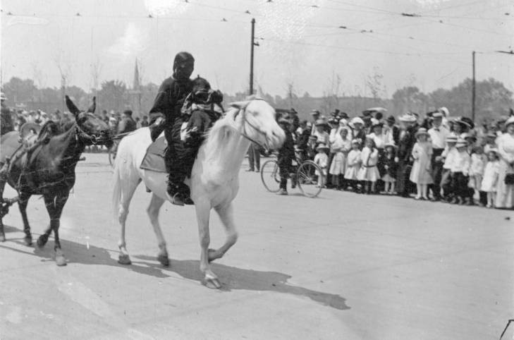 A Native American woman and her baby parading in the Sells Floto and Buffalo Bill Circus