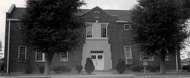 Photo of the Roosevelt County Museum. Bushes and trees also pictured.