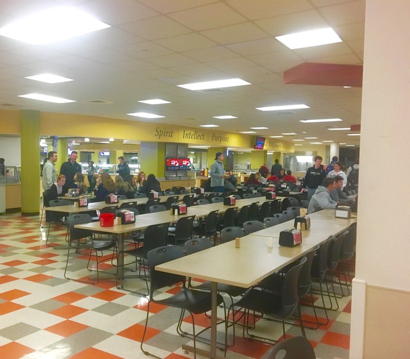 Inside of Campion where students are sitting and searching for food with other students.