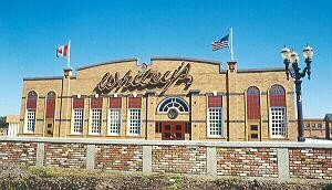 Yellow brick building with "Whitey's" script name above the doors.