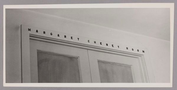 Black & White. Light colored double doors, closed. "Margaret Cheney Room" in black font above.