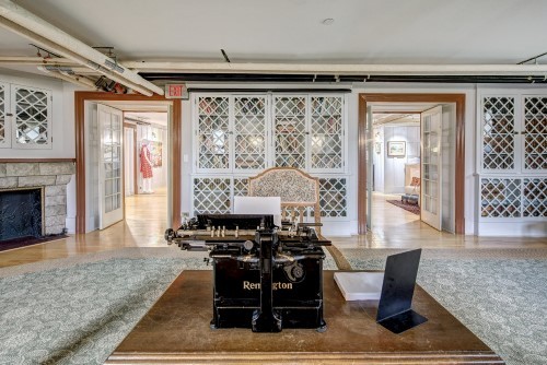 Image of library with typewriter on desk in centre of room