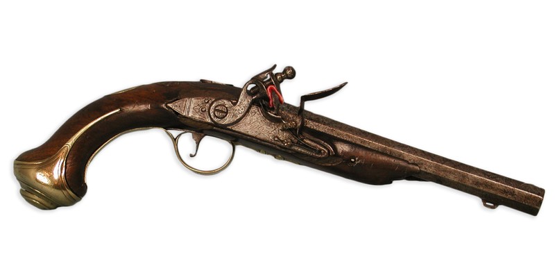 The lock is marked "Ketland," and was made by Ketland & Company of London and Birmingham, England. The wooden stock has German silver mounts, ornamented with floral designs, including an acorn tip at the end of the trigger guard. The other parts are iron or steel, except for the inlaid silver front sight. There is a lightly-engraved border at the breech end of the barrel and on the barrel tang. The smooth bore octagonal barrel is approximately .62 caliber.