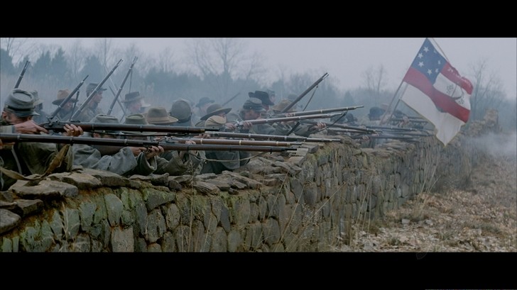Scene from Gods and Generals depicting Confederate soldiers firing from the stone wall