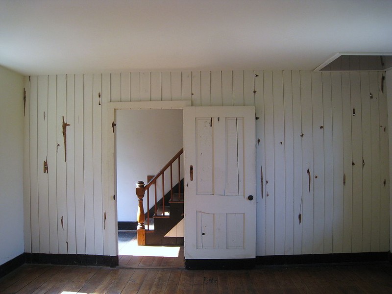 Interior of Innis House. Bullet homes pockmark the walls