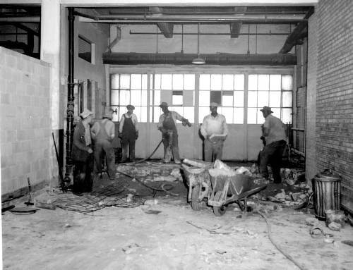 Construction workers clean up the facility in 1946, in preparation for the University of Illinois' impending move into the facility. The University's branch would remain for nearly two decades.