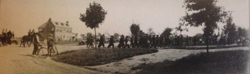 Huntington residents watch soldiers drill practice on the corner of 10th Street and 13th Ave at the location of the current stone arch entrances.