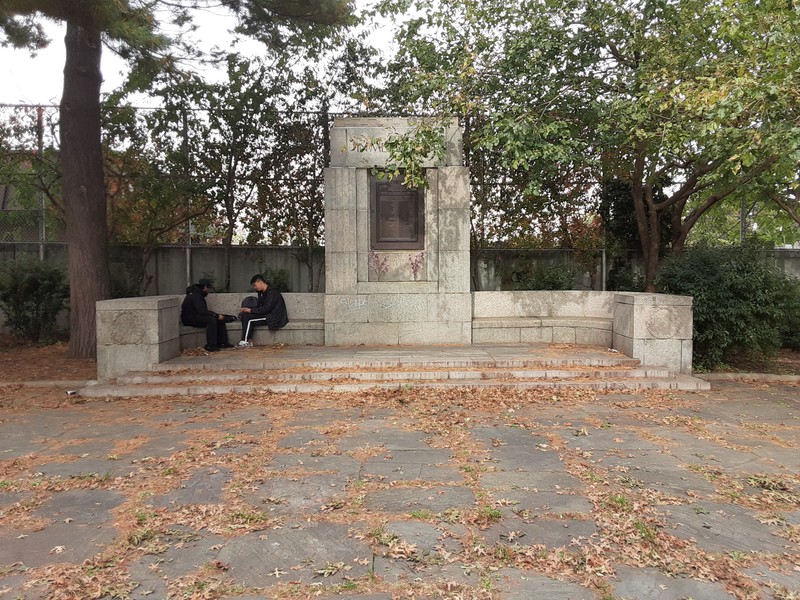 The Memorial with sitting people for scale.