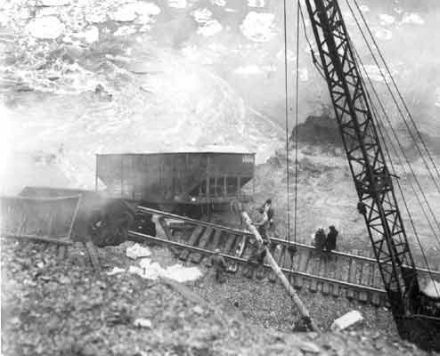 Workers dumping material into the river in an attempt to combat the water flow. Photo by Stephen N. Lukasik, copyright Lukasik Studio Archives.