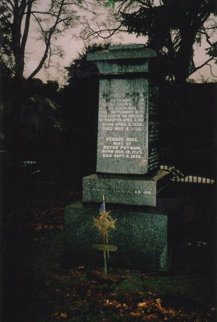 A gravestone with the names of famous figures.