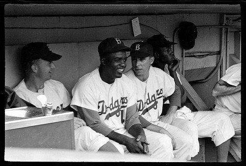 A picture of Jackie Robinson and Pee Wee Reese sitting in the Dodgers dugout during a game