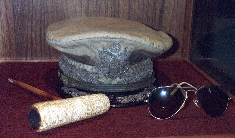 MacArthur's signature sunglasses and corncob pipe, most familiar from his return to the Philippines in 1944.