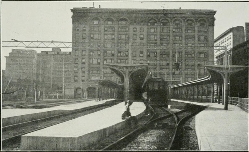 Behind the Pacific Electric Building, tracks in the yard elevated above the street serve interurbans, c. 1920