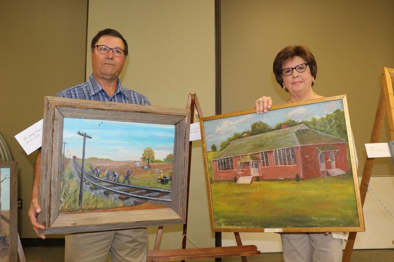 two painting, railway on the left, red brick schoolhouse on the right