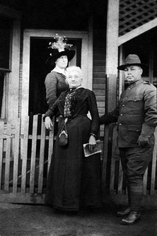 Mother Jones in front of the Pratt Boarding House where she was imprisoned temporarily in 1913. 
